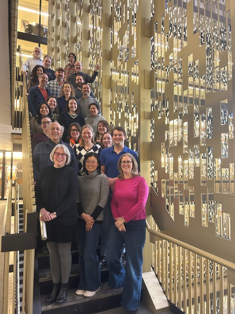 A group of people standing posing on a staircase